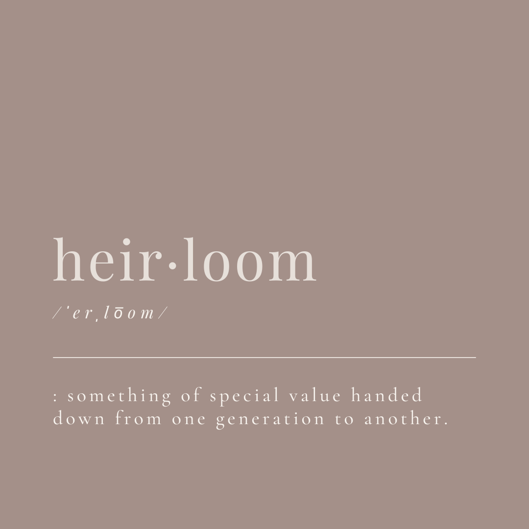 this image shows the definition of heirloom, and how it's pronounced on a mauve background