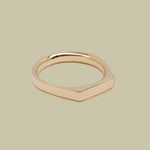 Gold ring on a beige background
