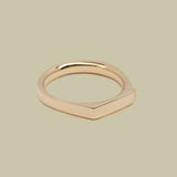 Gold ring on a beige background
