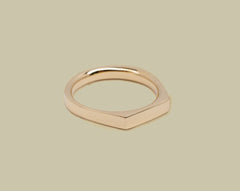 Gold ring on a beige background